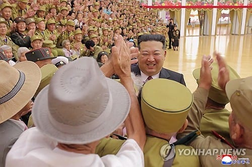 Kim Jong-un poses with war veterans for armistice anniversary