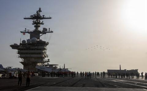 USS Abraham Lincoln sails past Singapore en route home after Middle East deployment