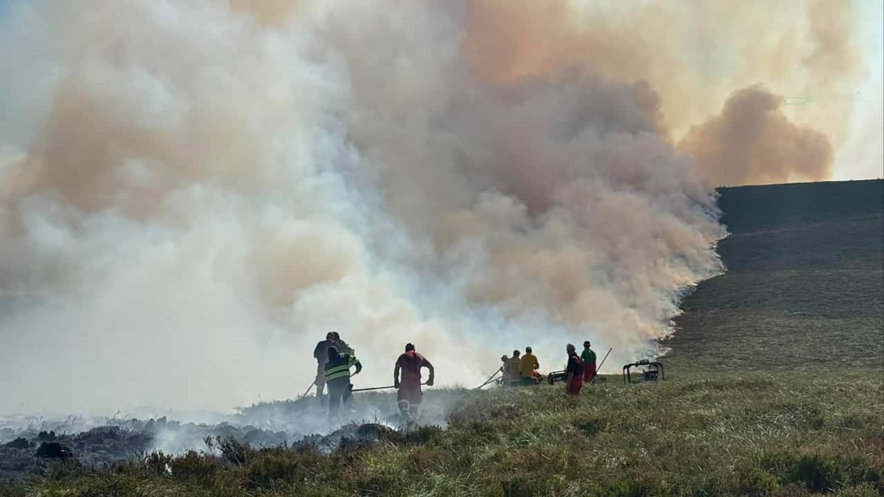 Helicopters waterbomb wildfire in UK's largest national park