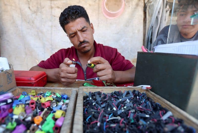 In Gaza's tent camps, a cigarette lighter becomes a lifeline