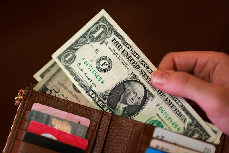 Dollar Firms on Iran Sanctions, Eases on Treasury Buyback Rumors