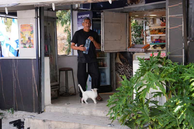 Israeli settlers place dozens of flags at Palestinian cafe entrance